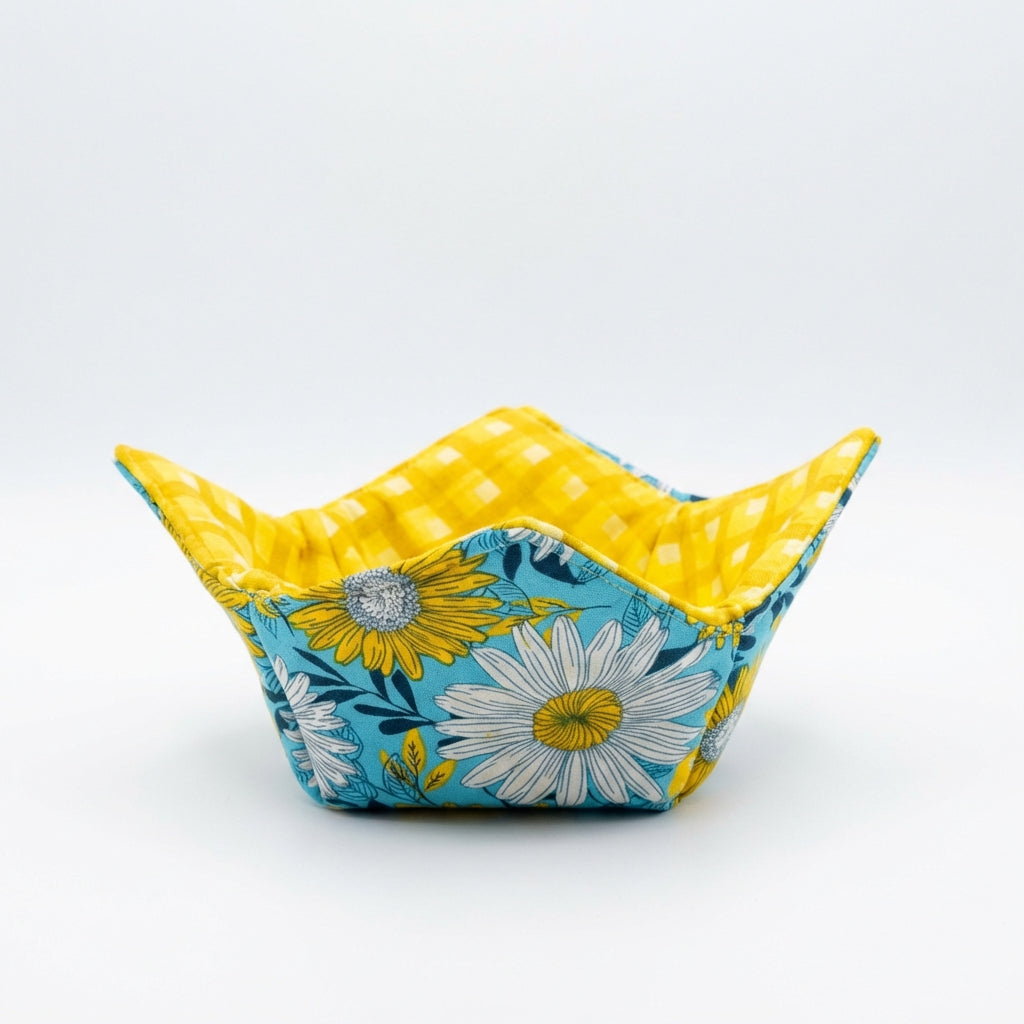 Fabric bowl with floral pattern and yellow interior on a white background