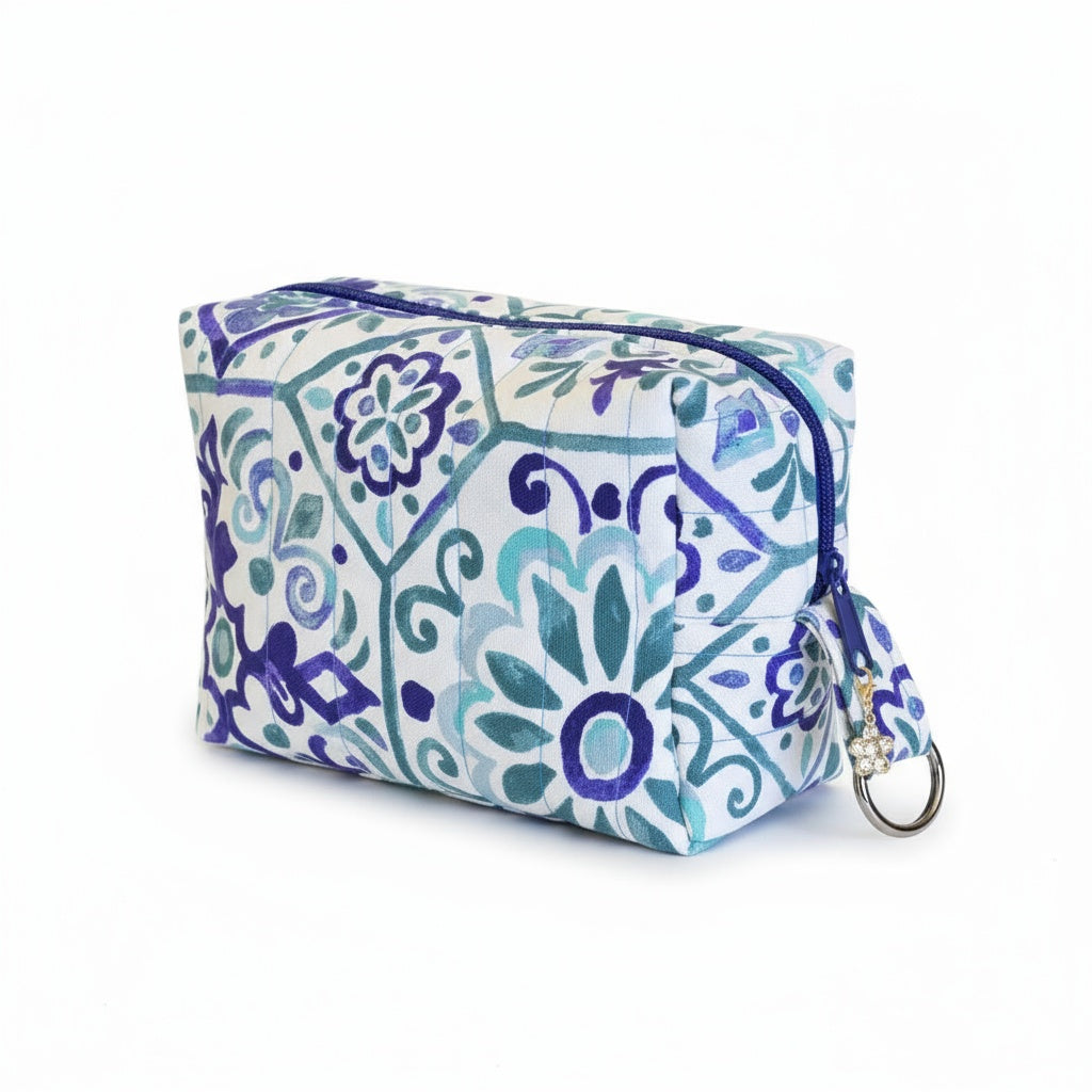 Cosmetic bag with blue and green floral pattern on a white background