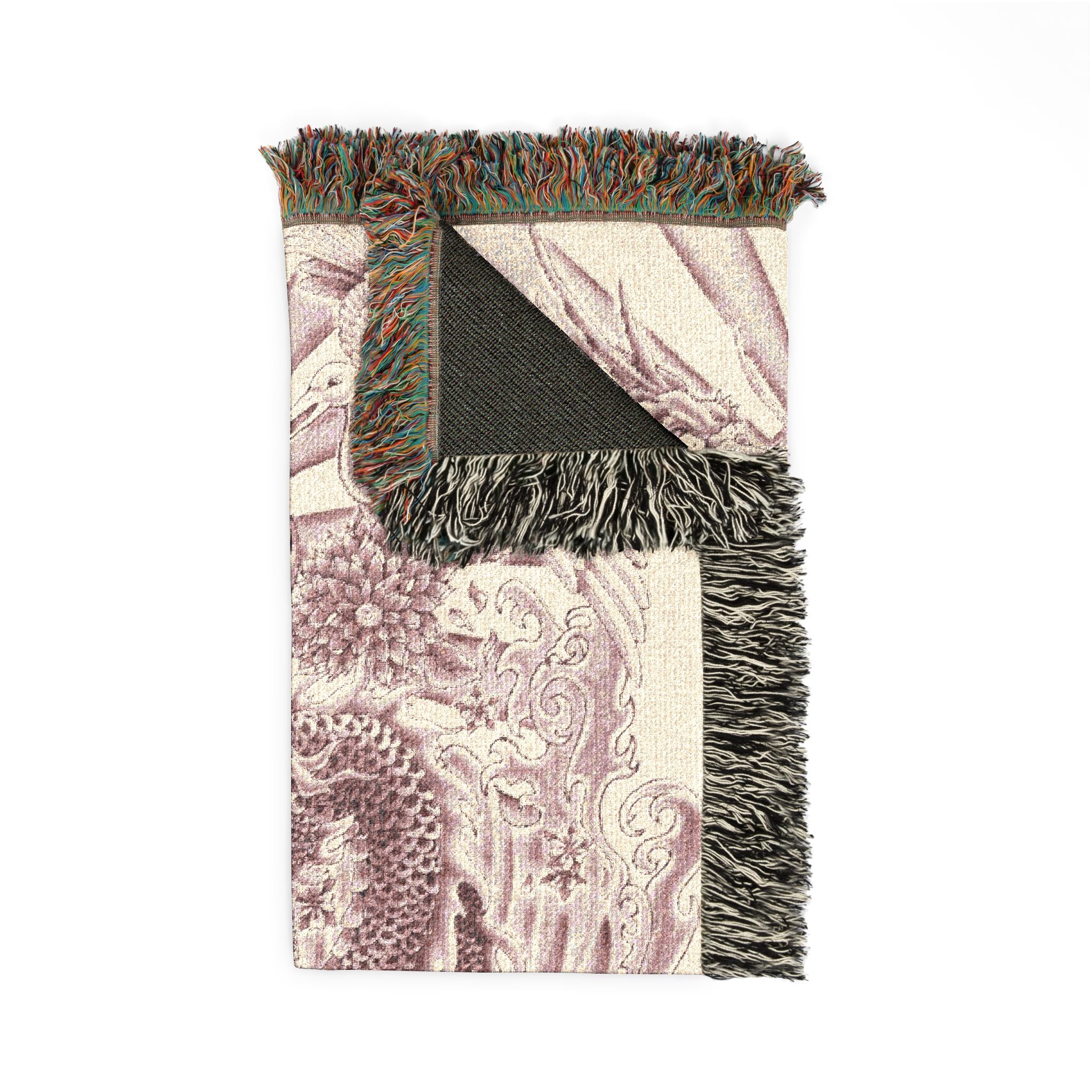 Decorative throw blanket with intricate pattern and fringed edges on a white background